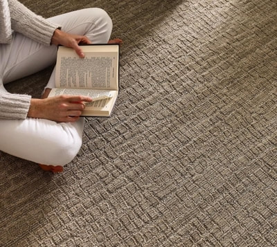 Woman reading on new carpet 